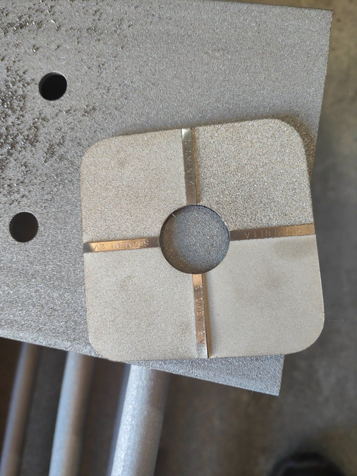 Surface profile comparator held against grit-blasted steel to grade the blast profile